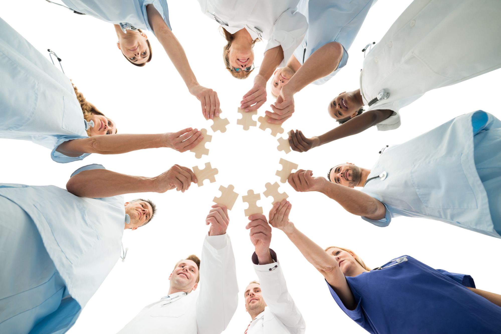 Medical professionals connecting puzzle pieces together