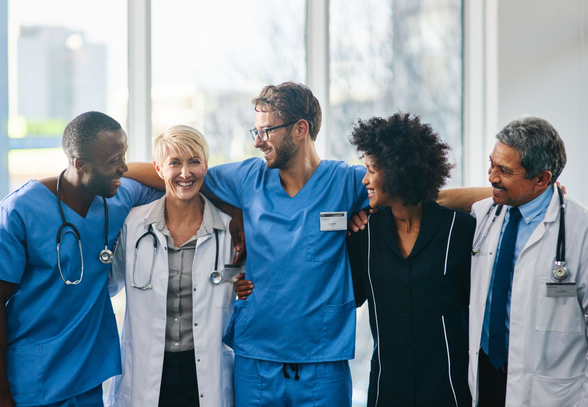 A group of doctors and medical professionals together in a bright clinical setting